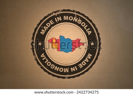 Brown paper with in its middle a retro style stamp Made in Mongolia include the map and flag of Mongolia.