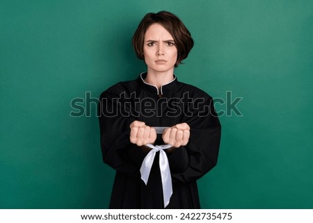 Photo of unhappy upset woman judge tied hands with tape discrimination no speech freedom isolated on green color background