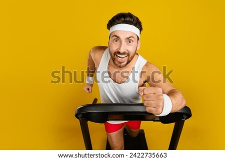 Photo of impressed funky guy sportswear running fast treadmill empty space isolated yellow color background