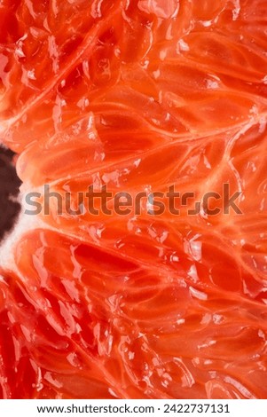 Macro photography of a grapefruit slice. Fresh fruit, pulp and peel detail
