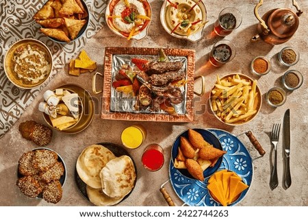 Arabic Cuisine: Middle Eastern traditional lunch. Ramadan "Iftar" . The Meal eaten by Muslims after sunset during Ramadan. Assorted of Egyptian oriental dishes. Top view with space.
 Royalty-Free Stock Photo #2422744263