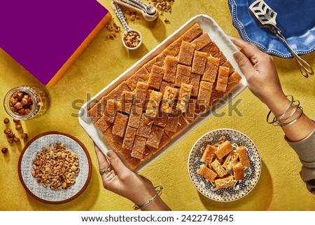 Traditional turkish, arabic dessert baklava assortment with pistachio. Ramadan sweets. with a mockup food box.
Middle Eastern desserts with tea and honey for ramadan iftar. Royalty-Free Stock Photo #2422747845