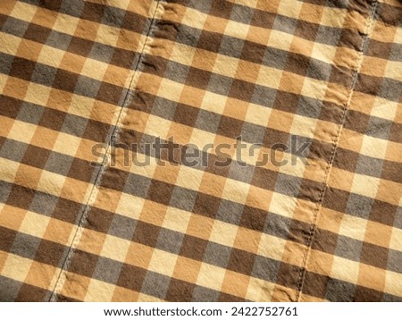 Yellow-gray check fabric background macro