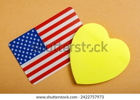 Heart with copy space for text and an American flag. Background with selective focus
