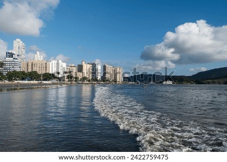 City of Santos, Brazil. Santos beach in Ponta da Praia neighborhood. In the background, the fortress of Barra at the entrance to the port channel.