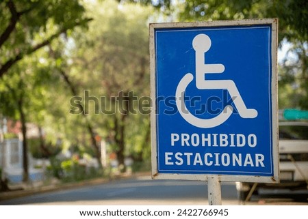 blue "no parking" handicapped parking placard. Sign in Spanish