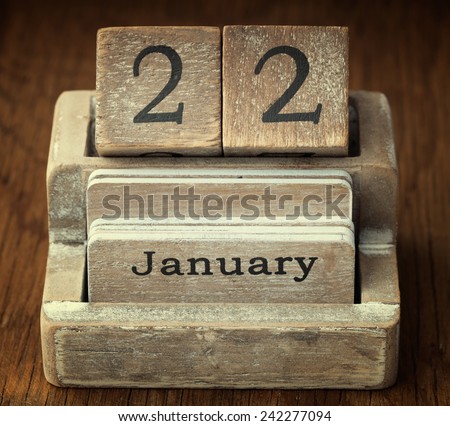 A very old wooden vintage calendar showing the date 22nd January on wood background