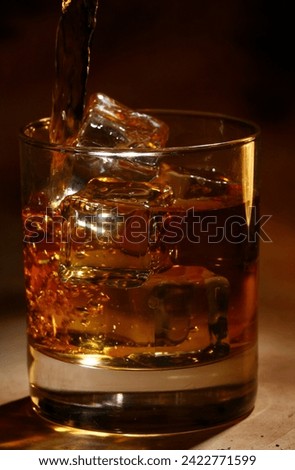 Beautiful picture of a glass of whiskey with ice cubes