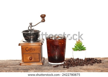 Americano ice coffee and coffee beans and coffee grinder vintage style put on old wooden with white background,concept isolated picture.