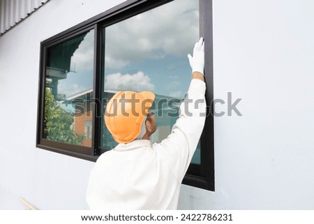 The glazier is about to install an aluminum-glass window. Royalty-Free Stock Photo #2422786231