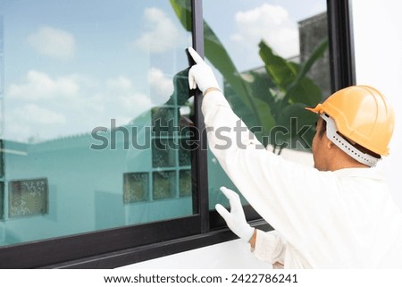 The glazier is about to install an aluminum-glass window. Royalty-Free Stock Photo #2422786241