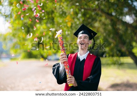 School or college graduation ceremony. Young man in academic regalia, gown and cap, celebration successful diploma certificate. High school graduate in robe, stole and mortar board. Royalty-Free Stock Photo #2422803751