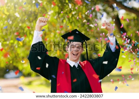 School or college graduation ceremony. Young man in academic regalia, gown and cap, celebration successful diploma certificate. High school graduate in robe, stole and mortar board. Royalty-Free Stock Photo #2422803807