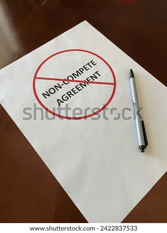 Concept image of a paper with the words non-compete agreement surrounded by a red prohibited sign with a pen Royalty-Free Stock Photo #2422837533
