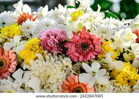 Beautiful flowers bouquet in different color tone and styles in Thailand market, nice background textures. Thai orchids, roses, carnations etc. Close up shot.