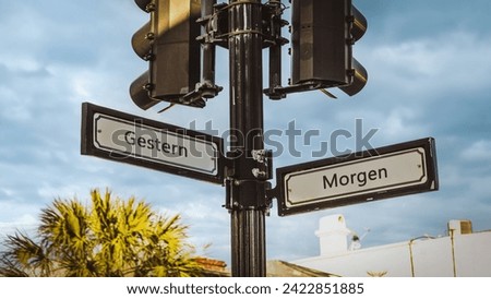 An image with a signpost pointing in two different directions in German. One direction points to tomorrow, the other points to yesterday.