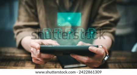 Multimedia Technology concept, Woman holding smartphone to manage digital files, VDO content creation online streaming, online class, Social media, content creator, watching video on internet. Royalty-Free Stock Photo #2422861309