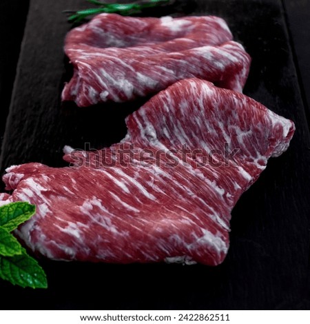 Raw iberian pork meat on black slate secreto ibérico Royalty-Free Stock Photo #2422862511