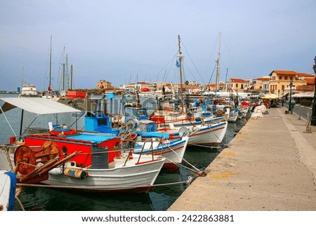Fishing boats in the harbour of Aegina, Greece. Traditional timber fishing boats tied up in the harbour with their catch of the day