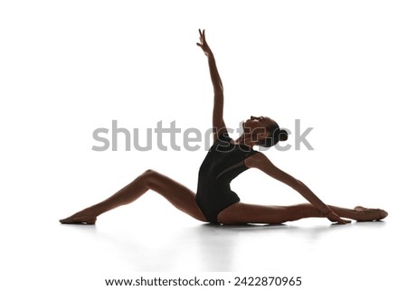 Talent show. Artistic, beautiful, elegant teen girl rhythmic gymnast performing against white studio background. Concept of sport, beauty and grace, competition, art, youth, hobby