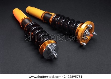 suspension tuning, coilovers, shock absorbers and front springs in yellow and gold colors for a sports drift car on a dark background	 Royalty-Free Stock Photo #2422895751