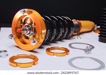 suspension tuning, coilovers, shock absorbers and front springs in yellow and gold colors for a sports drift car on a dark background	 Royalty-Free Stock Photo #2422895767