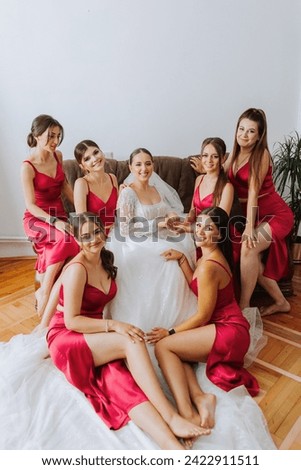 A beautiful bride and her bridesmaids are having fun in the morning. Wedding celebration. Happy girls at their best friend's wedding. A beautiful and elegant bride with her bridesmaids