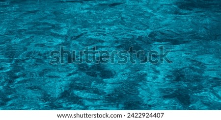 Rippled Water In the Swimming Pool. Blue fresh fountain water in the summer season. Backdrop of water in a fountain. Background with selective focus and copy space