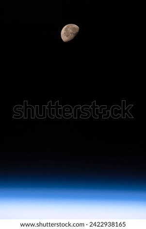The moon and the atmosphere of Planet Earth. Digital enhancement of an image by NASA