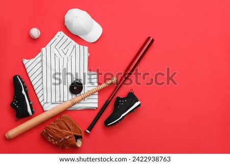 Flat lay composition with baseball uniform and sports equipment on red background. Space for text Royalty-Free Stock Photo #2422938763