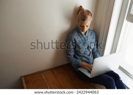 Woman, freelancer and laptop for blogging, remote work and internet connection on floor for info. Female person, editor and website for research or online news, writer and typing an article on tech