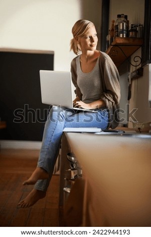 Woman, freelancer and laptop for writing, remote work and internet connection in kitchen for info. Female person, editor and website for research or online news, blog and typing an article on tech