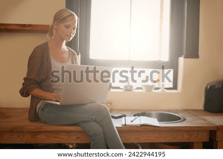 Woman, freelancer and laptop for journalism, remote work and internet connection in kitchen for info. Female person, editor and website for research or online news, blog and typing an article on tech