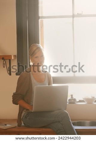 Woman, freelancer and laptop in portrait, remote work and internet connection in kitchen for info. Female person, editor and website for research or online news, blog and typing an article on tech