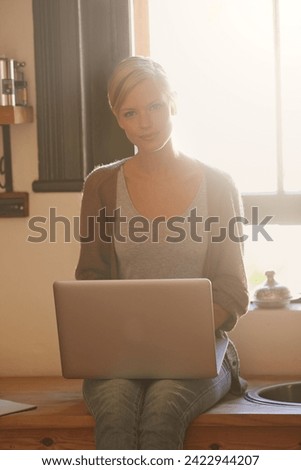 Woman, freelancer and laptop in portrait, writing and internet connection in kitchen for info. Female person, editor and website for research or online news, blogging and typing an article on tech