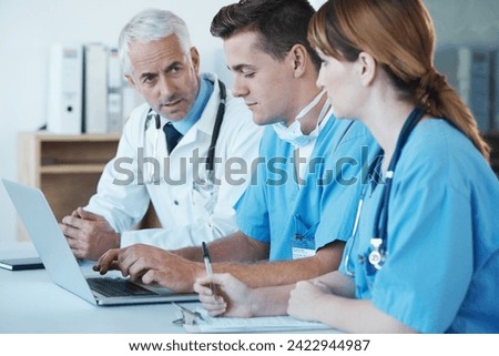Laptop, discussion and doctor with nurses in hospital for medical diagnosis or treatment meeting. Team, computer and senior surgeon talking to healthcare workers for surgery research in clinic.