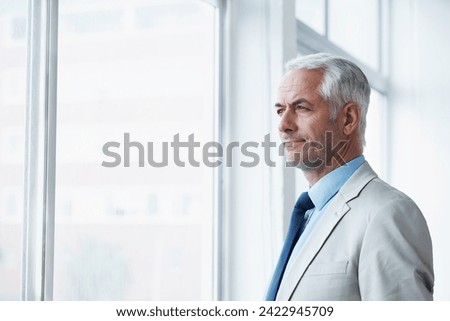 Mature, man and thinking of business at window, planning for future and idea for office. Professional, mindset and businessman remember a dream for company and consider decision, choice or solution Royalty-Free Stock Photo #2422945709