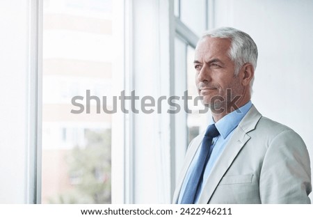 Mature, man and thinking about future of business at window, planning an idea for office. Professional, mindset and businessman remember a dream for company and consider decision, choice or solution Royalty-Free Stock Photo #2422946211
