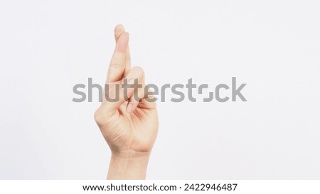 Good luck hand sign on white background. Royalty-Free Stock Photo #2422946487