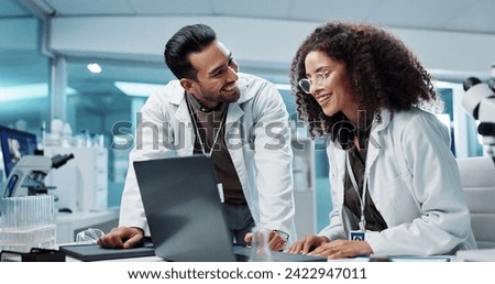 Scientist, teamwork and happy with laptop in laboratory for test breakthrough, pharmaceutical review or success. Science, collaboration or technology for research, discussion and digital analysis Royalty-Free Stock Photo #2422947011