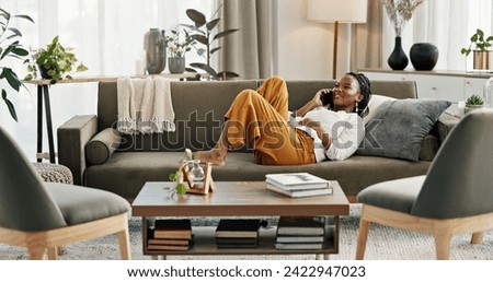 Phone call, laugh and black woman on sofa for talking, funny conversation and online discussion. Networking, communication and person relax on smartphone with humor, joke and comedy chat in home Royalty-Free Stock Photo #2422947023