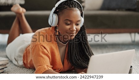 Home, smile and black woman with a headphones, streaming music or sound in a living room. African person on a sofa, apartment or girl with headset, listening to audio or relax with happiness or song
