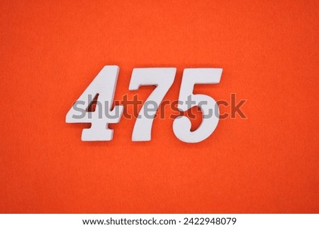 Orange felt is the background. The numbers 475 are made from white painted wood. Royalty-Free Stock Photo #2422948079