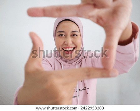 Happy Muslim Asian Girl In Pink Headscarf Making Frame With Fingers, Capturing Photo, Framing Face, Standing Over White Background, Closeup.