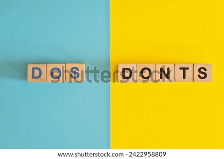 Dos and Donts concept. Wooden blocks typography in bright blue and yellow background.	