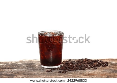 Coffee beans spreading on old wooden and Americano ice coffee with concept isolated picture.