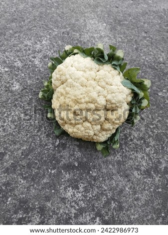 Cauliflower on asphalt motif background.