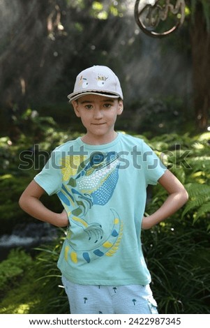 Beautiful boy, look of fashion child, outfit of cute kid in Chom Cafe in Chiang Mai, Thailand. Thai nature, landmark. Wild scenery Royalty-Free Stock Photo #2422987345