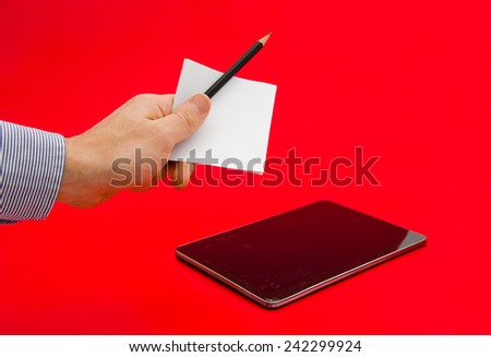 Paper notes and a pencil in comparison with a modern high tech expensive tablet with a broken display touch screen on a red alerted serious important background suggesting choice between old modern