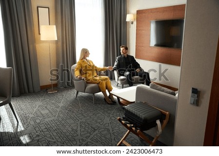 Traveling couple relaxing before the road in a hotel room